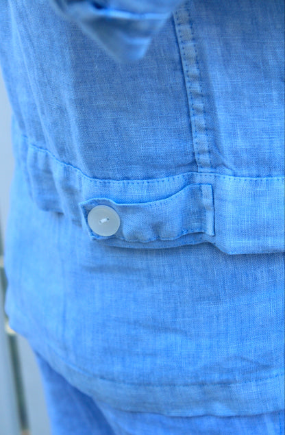 Close-up of a sky blue jacket with a button
